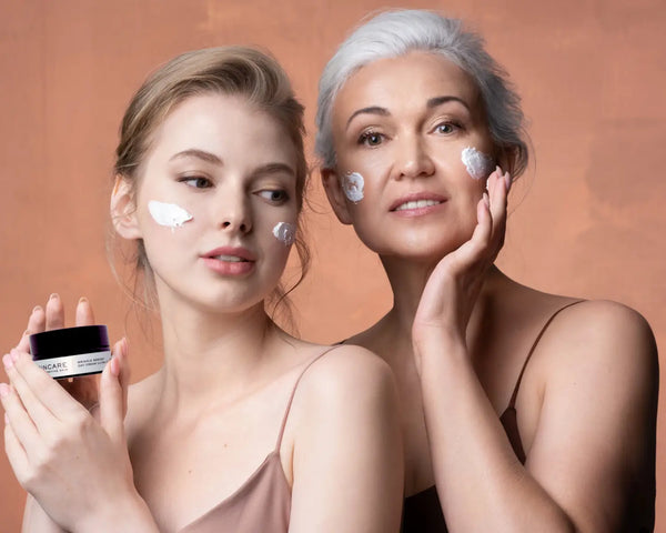 Beautiful Mother and Daughter applying rich moisturiser to their face