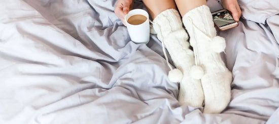 A woman with winter dry skin is wearing warm socks to keep herself warm whilst protecting her skin barrier