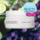 White cylindrical jar of qed skincare the body cream with bergamot and lavender for sensitive skin to help skin feel beautiful