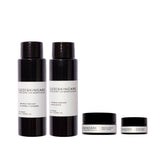 Black glass bottles and jars with minimalist white labels from red skincare wrinkle rewind travel set for sensitive skin